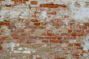 Red Old Weathered Brick Wall With Beaten Pieces Of Whitewash, Putty And Plaster