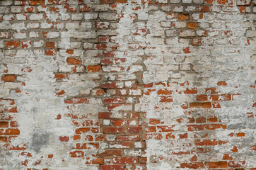 Red Old Weathered Brick Wall With Beaten Pieces Of Whitewash, Putty And Plaster