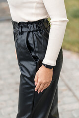 Young woman in black leather pants on the street. Womens Trendy Faux Leather Pants