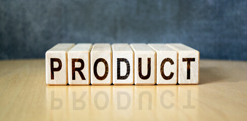 The inscription PRODUCT on wooden cubes on the background of a slate board. Business, economics and finance concept.