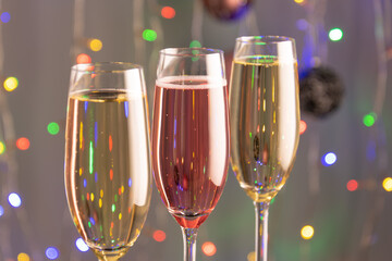 Three glasses of champagne with lights in the background.