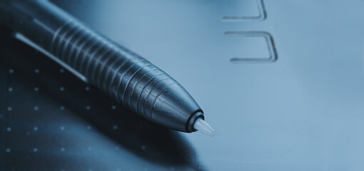 Electronic pen on a digitizer tablet fragment , close up, Images with Copy Space