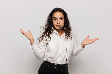 young hispanic woman feeling puzzled and confused, doubting, weighting or choosing different...