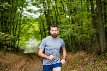 handsome trail runner running in nature