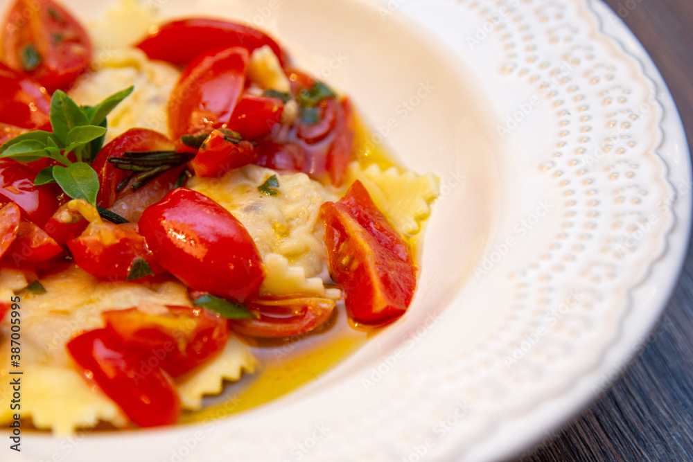 Wall mural ravioli with pieces of fresh tomato dipped in olive oil