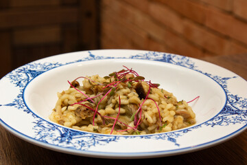Risotto of vitello with funghi porcini sauce and micro-leaf of beet