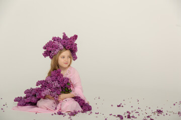 Fototapeta premium Little cute bright girl in the studio with lilac
