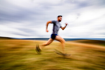 Fototapeta na wymiar handsome trail runner running in nature