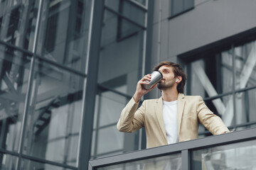 Fototapeta premium Businessman having coffee break outside the office