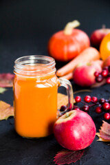 Halloween cocktail, pumpkin orange drink with spices. Dark vintage dirty background. Creative atmospheric decoration