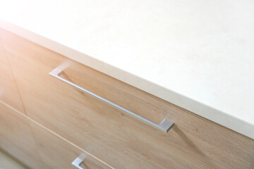 Fragment of kitchen counter top made with white marble