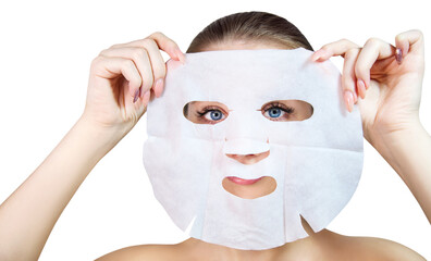 Young woman holds white cloth facial mask.