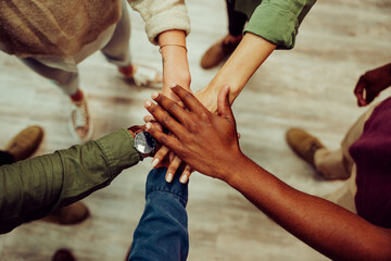 Successful business group hands stacked together showing unity and team work. - obrazy, fototapety, plakaty
