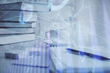 Double exposure of financial chart drawing and desktop with coffee and items on table background. Concept of forex market trading