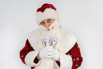 Santa Claus holds money in his hands. Isolated on light background