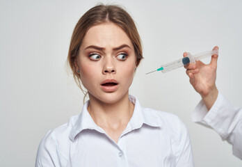 scared woman and syringe with needle near face