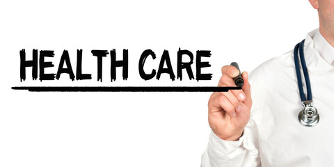 Doctor writes the word - HEALTH CARE. Image of a hand holding a marker isolated on a white background.
