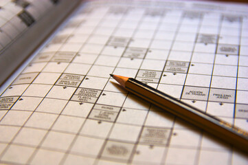 Close-up of a crossword next to a pencil