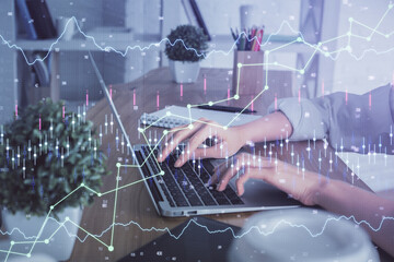 Double exposure of woman hands typing on computer and forex chart hologram drawing. Stock market invest concept.