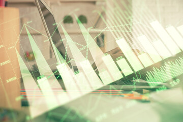 Double exposure of woman hands typing on computer and forex chart hologram drawing. Stock market invest concept.