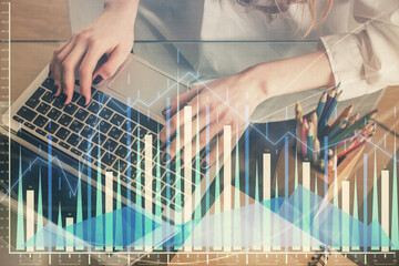 Double exposure of woman hands typing on computer and forex chart hologram drawing. Stock market invest concept.