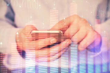 Multi exposure of man's hands holding and using a digital phone and forex graph drawing. Financial market concept.