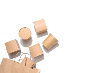 Cardboard containers for food, drinks and items drop out of the craft bag.  Isolated on white...