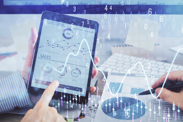 Multi exposure of man's hands holding and using a phone and financial chart drawing. Market analysis concept.