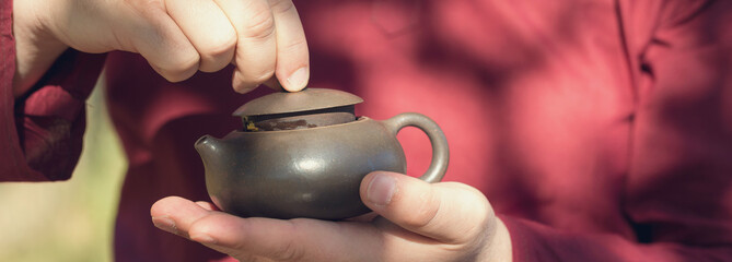 Chinese tea ceremony. Ceramic teapot made of clay and bowls on a wooden background.