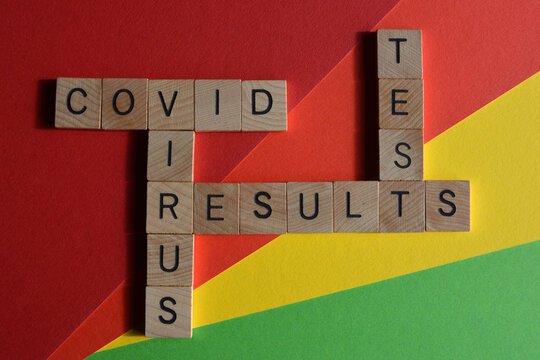 Covid, Virus, Test, Results In Wooden Alphabet Letters In Crossword Form On Colourful Background