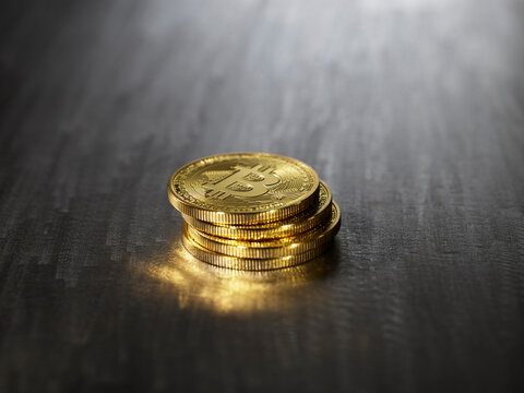 Four bitcoins stacked together