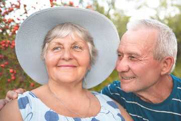 Authentic outdoor shot of aging couple having fun in the garden and blessed with love.