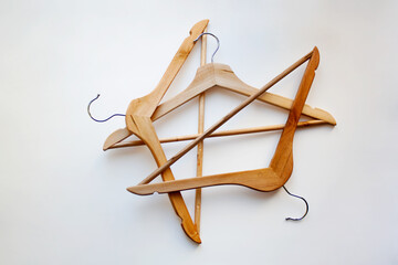 Three wooden hangers isolated on white background