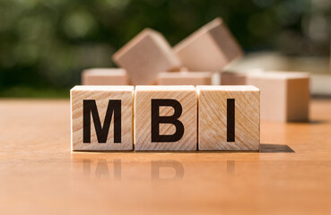 Text MBI on wooden cubes on a wooden background