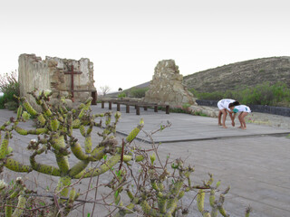 children playing Canarian wrestling in the ruins of an old hermitage, in the town of El Escobonal,...