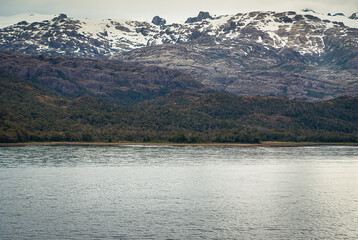 Sarmiento Channel, Chile - December 11, 2008: Amalia Glacier and Fjord. snow on range of black rock...