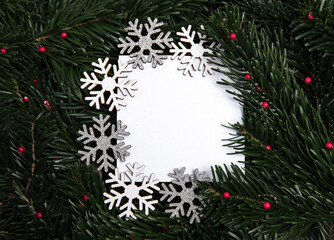 Card on pine background with snowflakes