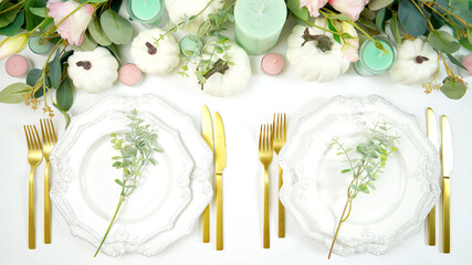 Happy Thanksgiving table setting with white vintage style plates, gold silverware, and centerpiece...