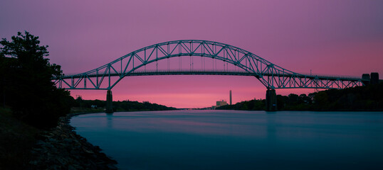Sagamore Bridge and Cape Cod Canal Twilight Nightscape Silhouette Photo, Pink, and Turquoise Colored Cross-processed Panoramic Image.