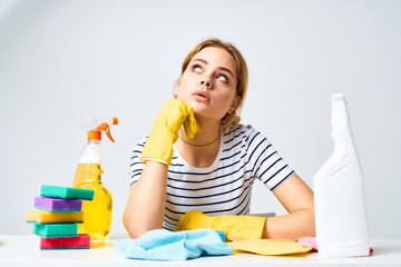 The cleaning lady sits at the table detergent work service