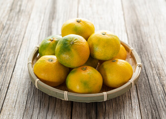 Early Japanese mandarin oranges on an old wooden board