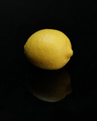 take a photo of fresh lemon against a black background, so it looks luxurious and elegant. Ready to use as an advertising image.