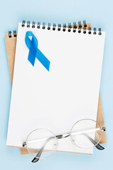 blue prostate ribbon on open notebook