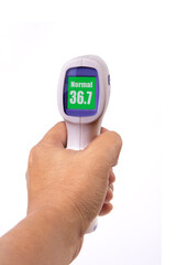 Hand holding handheld infrared thermometer that showing body temperature.