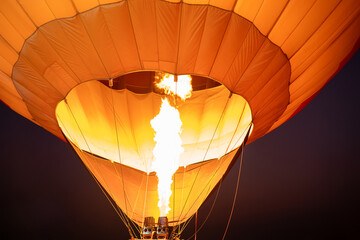 Close up of fire bursts in the balloon at evening with twilight sky 
