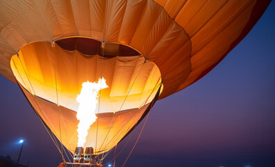 Close up of fire bursts in the balloon at evening with twilight sky 