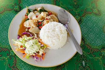 Thai food is in the plate on the table.
