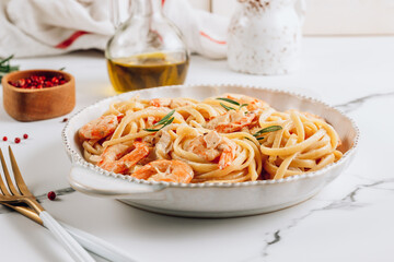 Pasta tagliatelle with shrimps in creamy sauce