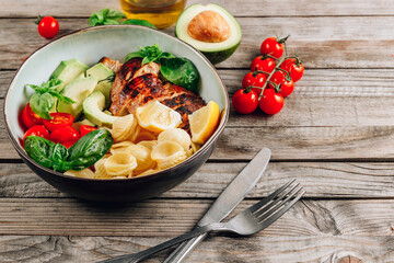 Grilled chicken with orecchiette pasta, fresh tomato and basil leaves