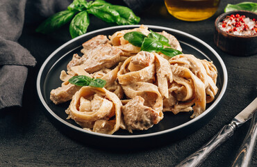 Authentic Italian fettuccine alfredo pasta dish with grilled chicken breast